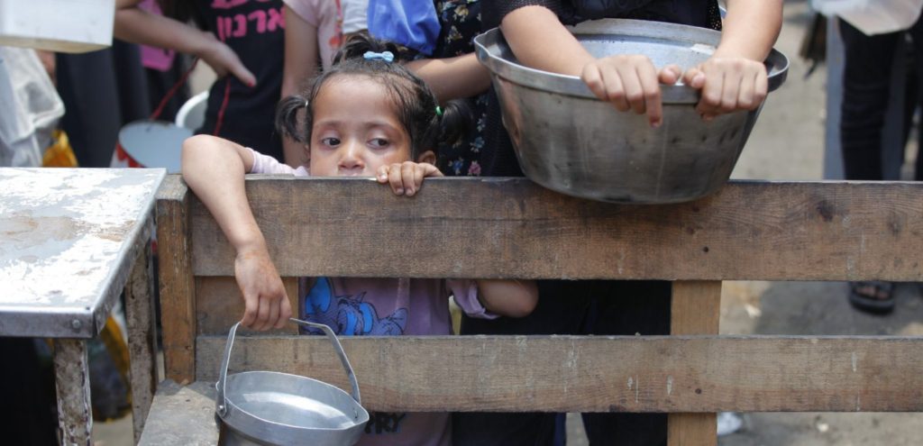 children waiting for humanitarian aid in Gaza